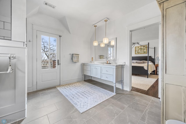 full bathroom with visible vents, ensuite bathroom, vaulted ceiling, and vanity