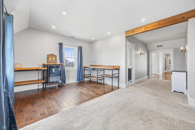 interior space with visible vents, lofted ceiling, wood finished floors, baseboards, and recessed lighting