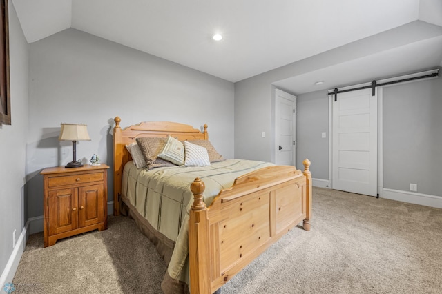 bedroom with light colored carpet, a barn door, recessed lighting, baseboards, and vaulted ceiling