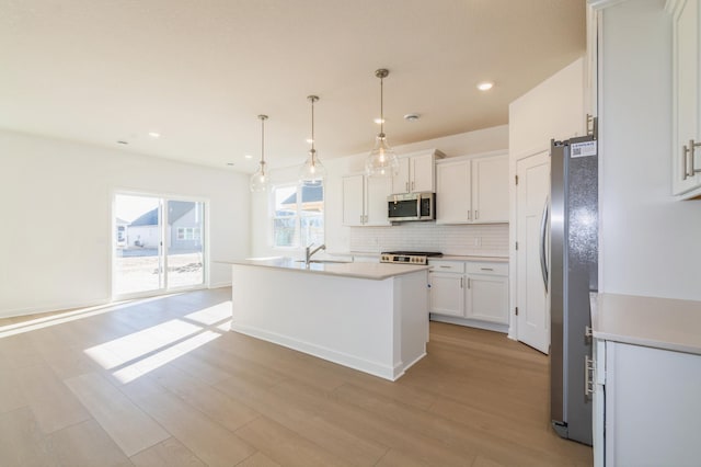 15149 Quince St NW, Andover, MN 55304 - kitchen with recessed lighting, white cabinetry, a sink, appliances with stainless steel finishes, and backsplash