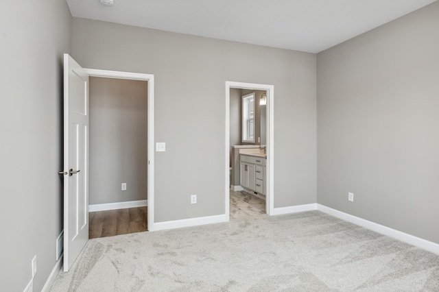 15149 Quince St NW, Andover, MN 55304 - unfurnished bedroom featuring light colored carpet, baseboards, and ensuite bath