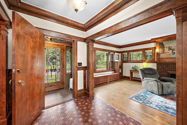 2511 12th Ave N, Minneapolis, MN 55411 - foyer entrance with crown molding, healthy amount of natural light, wainscoting, a fireplace, and a decorative wall