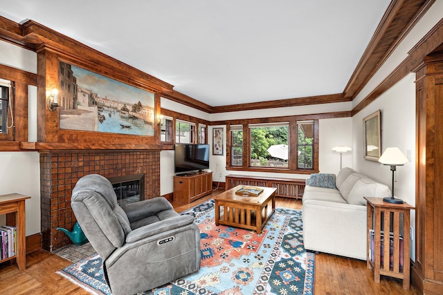 2511 12th Ave N, Minneapolis, MN 55411 - living room featuring radiator, ornamental molding, a fireplace, wood finished floors, and baseboards