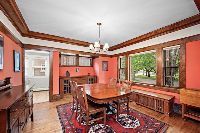 2511 12th Ave N, Minneapolis, MN 55411 - dining area featuring a chandelier, a baseboard heating unit, ornamental molding, light wood-type flooring, and radiator heating unit