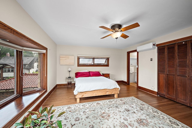 2511 12th Ave N, Minneapolis, MN 55411 - bedroom with multiple windows, an AC wall unit, baseboards, and dark wood finished floors