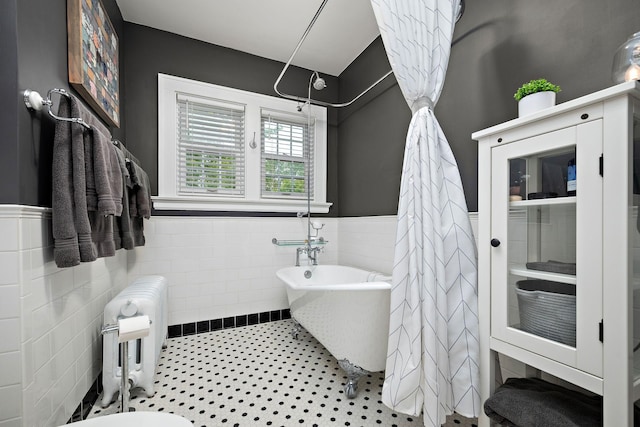 2511 12th Ave N, Minneapolis, MN 55411 - full bathroom featuring wainscoting, a soaking tub, radiator, and tile walls