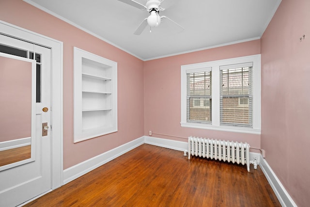 2511 12th Ave N, Minneapolis, MN 55411 - spare room featuring radiator heating unit, wood finished floors, ornamental molding, baseboards, and a ceiling fan