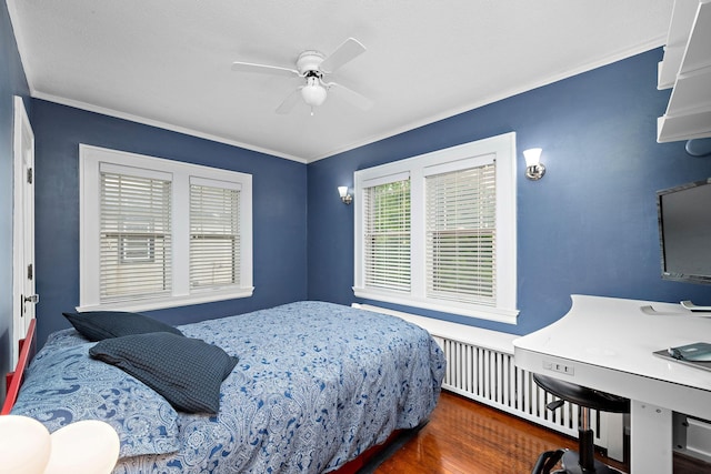 2511 12th Ave N, Minneapolis, MN 55411 - bedroom with wood finished floors, ornamental molding, an office area, a ceiling fan, and radiator heating unit