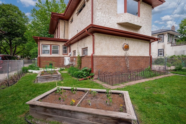 2511 12th Ave N, Minneapolis, MN 55411 - rear view of property featuring a vegetable garden, stucco siding, and brick siding