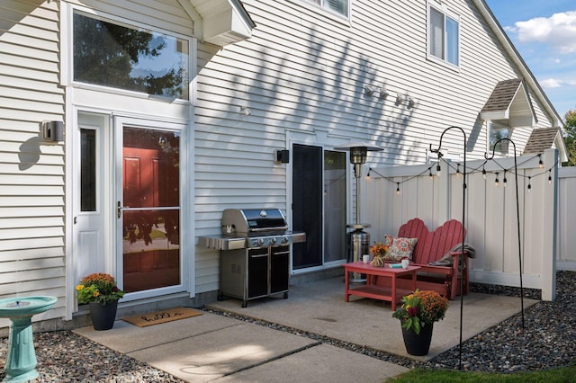 view of patio featuring area for grilling and fence