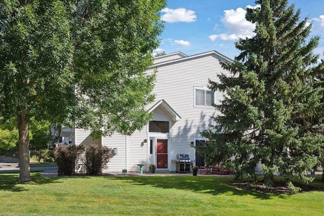 view of front of home with a front lawn and a patio area
