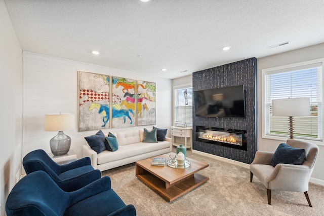 living room featuring carpet, a fireplace, recessed lighting, and visible vents