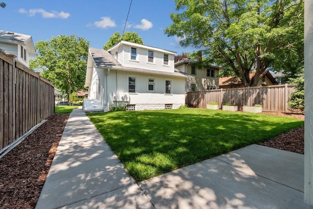 2170 Palace Ave, Saint Paul, MN 55105 - rear view of property with fence, a shingled roof, and a lawn