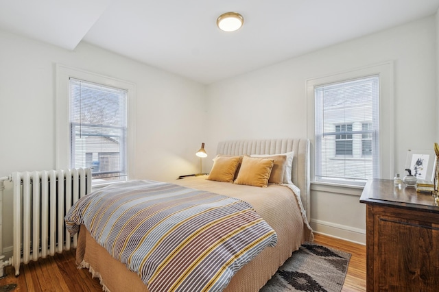 2170 Palace Ave, Saint Paul, MN 55105 - bedroom with radiator, baseboards, and wood finished floors