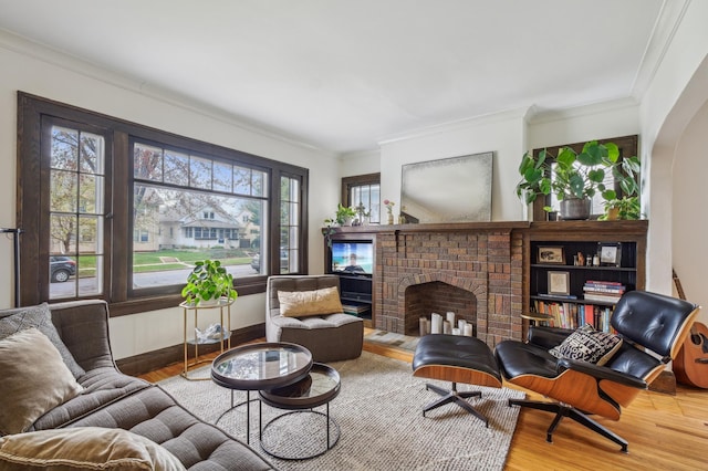2170 Palace Ave, Saint Paul, MN 55105 - living area with baseboards, ornamental molding, a brick fireplace, and wood finished floors