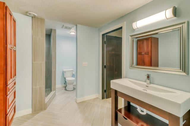 bathroom featuring toilet, baseboards, walk in shower, and tile patterned flooring