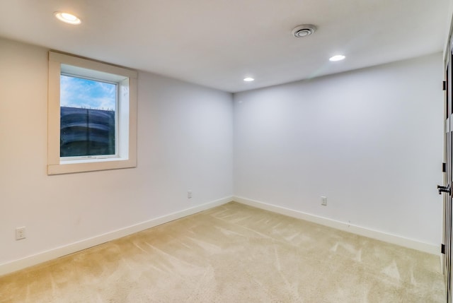 spare room featuring baseboards, recessed lighting, and light colored carpet