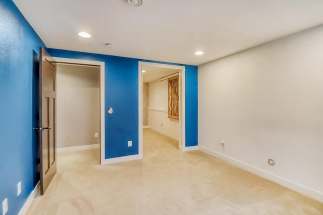 unfurnished bedroom featuring baseboards, a closet, recessed lighting, and light colored carpet