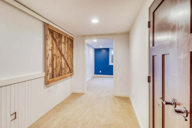 hallway featuring light carpet and recessed lighting