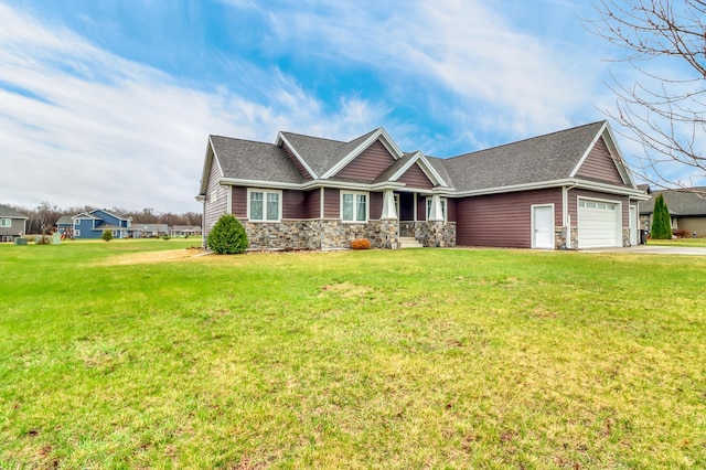 craftsman-style house with a front yard, an attached garage, driveway, and stone siding