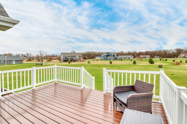 deck with a lawn and a residential view