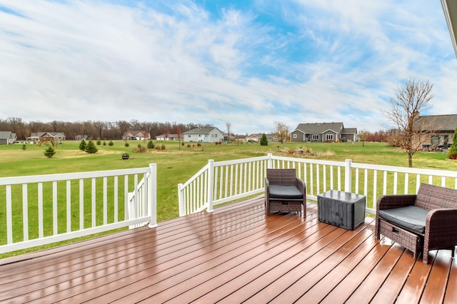 deck featuring a lawn and a residential view