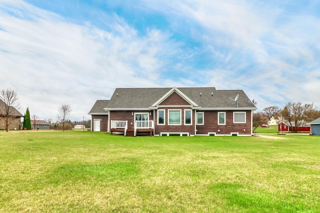 back of property with a lawn and a deck
