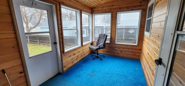 carpeted office space featuring wood walls and wood ceiling