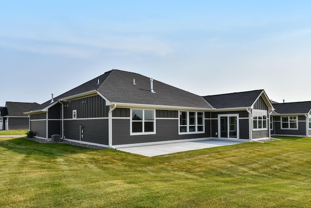 7521 Ocean Ave, Otsego, MN 55330 - back of property with a lawn, board and batten siding, a patio area, and roof with shingles
