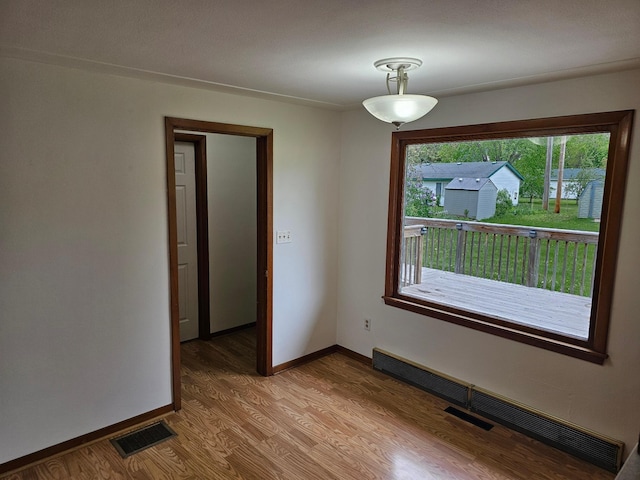 unfurnished room with light wood finished floors and baseboards