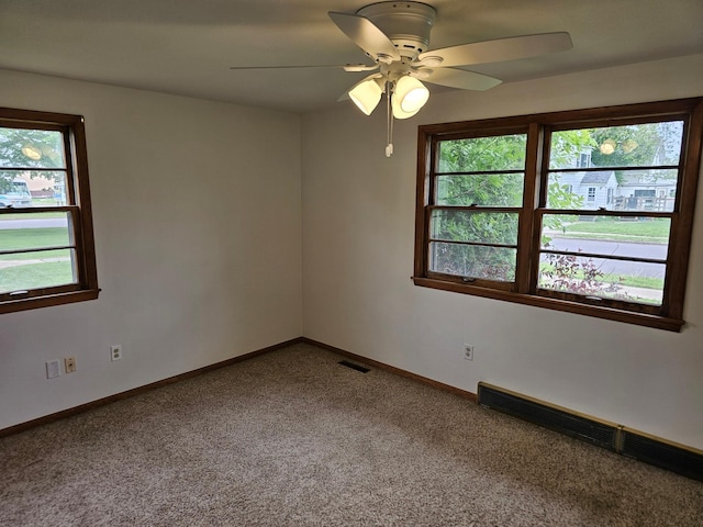 unfurnished room featuring carpet, ceiling fan, and baseboards