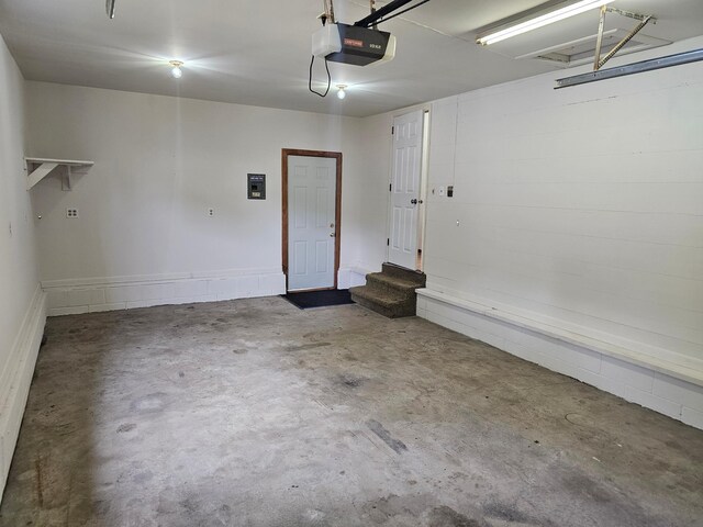 garage featuring a garage door opener and electric panel