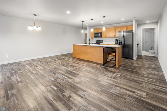 kitchen featuring recessed lighting, dark wood-style flooring, appliances with stainless steel finishes, and baseboards