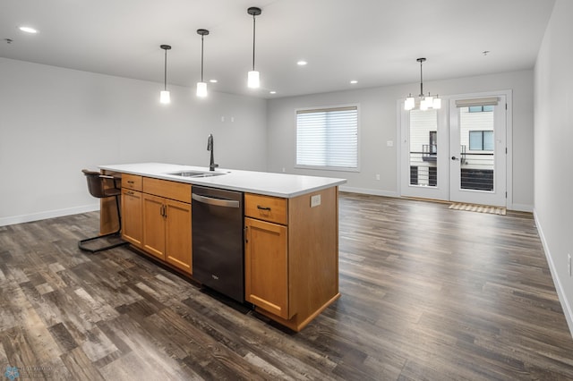 kitchen featuring stainless steel dishwasher, dark wood-style floors, a sink, and light countertops