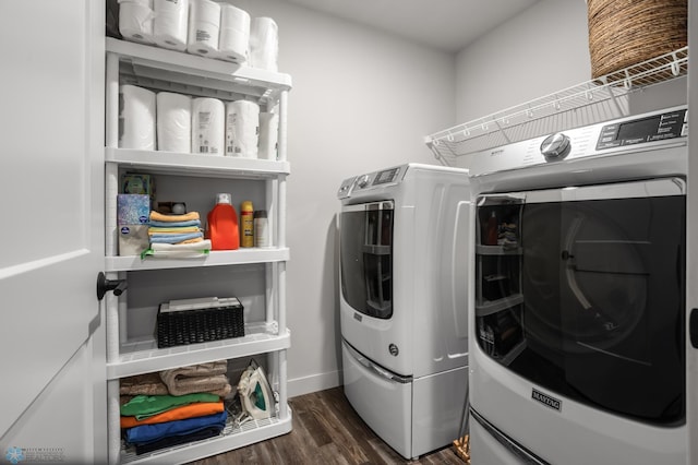 clothes washing area featuring laundry area, dark wood finished floors, and washing machine and dryer