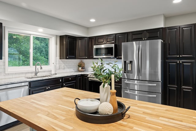 6360 Teton Ln, Chanhassen, MN 55317 - kitchen featuring appliances with stainless steel finishes, wooden counters, tasteful backsplash, and recessed lighting