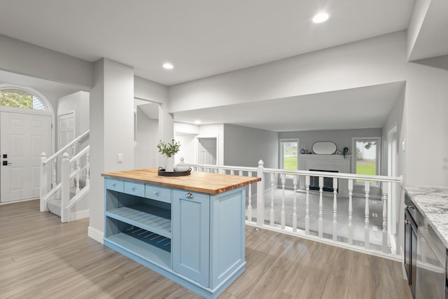6360 Teton Ln, Chanhassen, MN 55317 - kitchen featuring wood counters, blue cabinetry, light wood-style flooring, recessed lighting, and open shelves