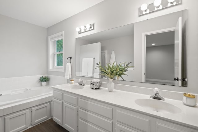 6360 Teton Ln, Chanhassen, MN 55317 - full bathroom featuring double vanity, a bath, and wood finished floors