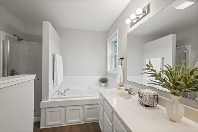 6360 Teton Ln, Chanhassen, MN 55317 - full bathroom featuring a stall shower, a bath, vanity, and wood finished floors