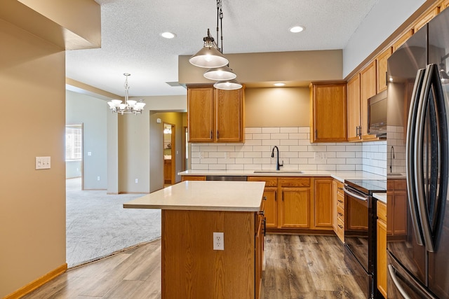 14012 54th Ave N Unit 4, Plymouth, MN 55446 - kitchen featuring black appliances, a sink, a kitchen island, light countertops, and decorative backsplash
