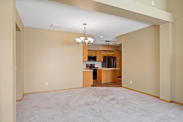 14012 54th Ave N Unit 4, Plymouth, MN 55446 - kitchen with black appliances, a chandelier, open floor plan, brown cabinets, and carpet flooring