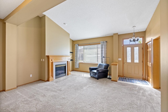 14012 54th Ave N Unit 4, Plymouth, MN 55446 - entrance foyer with a chandelier, carpet floors, a textured ceiling, baseboards, and a glass covered fireplace