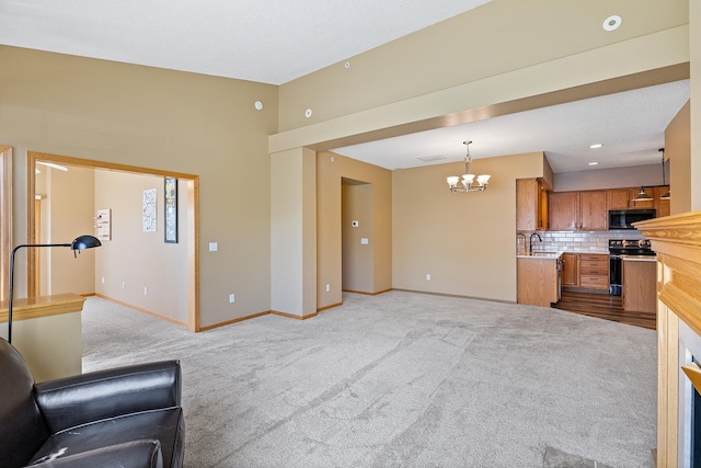 14012 54th Ave N Unit 4, Plymouth, MN 55446 - unfurnished living room featuring a chandelier, carpet flooring, baseboards, a sink, and lofted ceiling