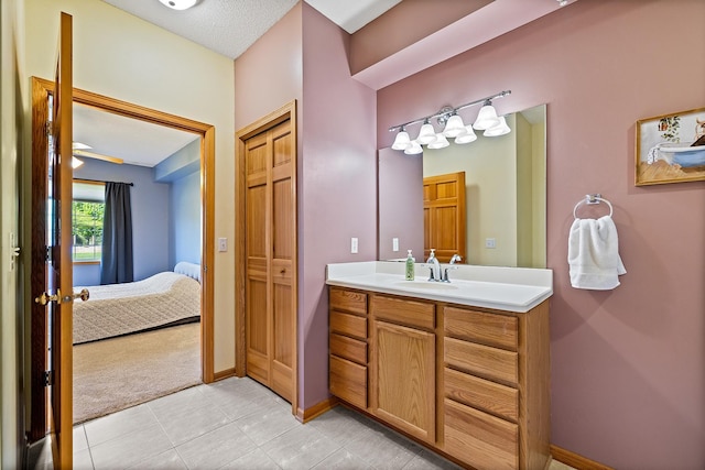 14012 54th Ave N Unit 4, Plymouth, MN 55446 - bathroom with vanity, ensuite bathroom, tile patterned floors, and baseboards