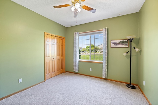 14012 54th Ave N Unit 4, Plymouth, MN 55446 - unfurnished bedroom with carpet, a textured ceiling, baseboards, and a closet