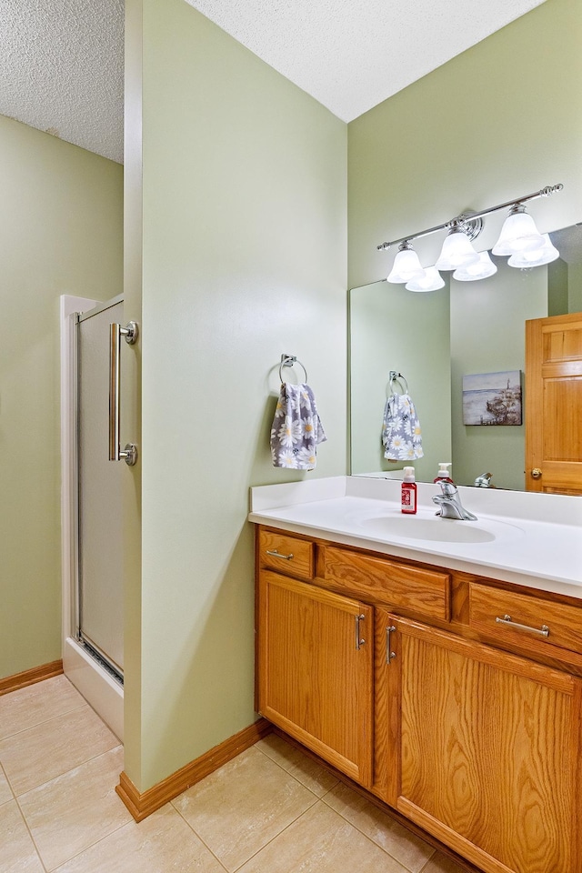 14012 54th Ave N Unit 4, Plymouth, MN 55446 - full bath featuring tile patterned floors, a stall shower, vanity, a textured ceiling, and baseboards