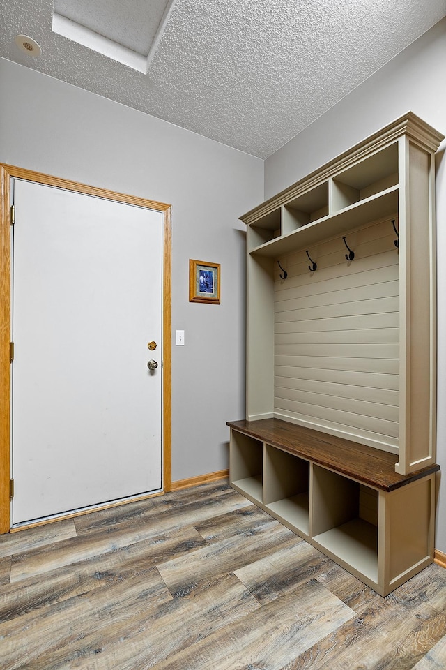 14012 54th Ave N Unit 4, Plymouth, MN 55446 - mudroom featuring a textured ceiling and wood finished floors