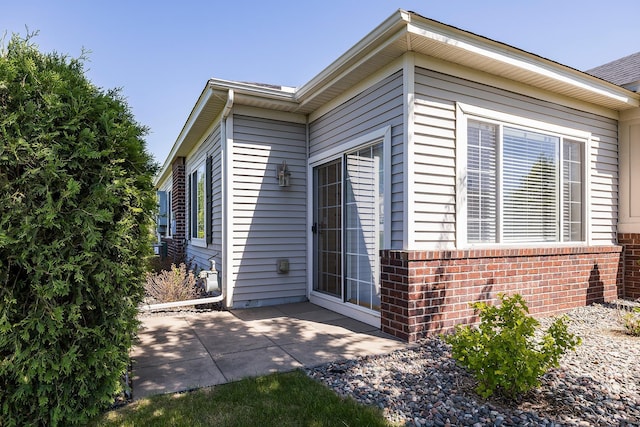 14012 54th Ave N Unit 4, Plymouth, MN 55446 - view of side of property featuring a patio area and brick siding