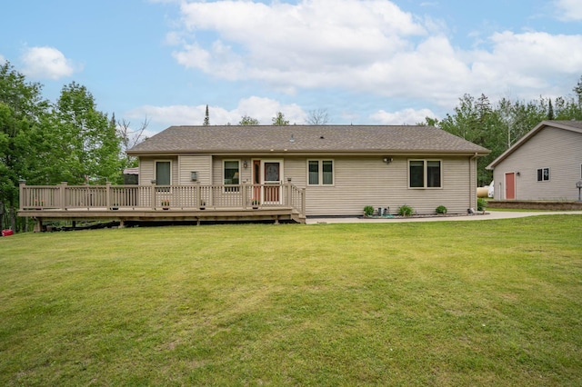back of property featuring a lawn and a deck