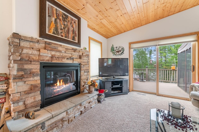 carpeted living area featuring wooden ceiling, vaulted ceiling, and a stone fireplace